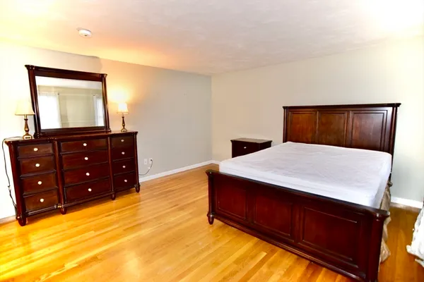 a bed room with a bed and a dresser