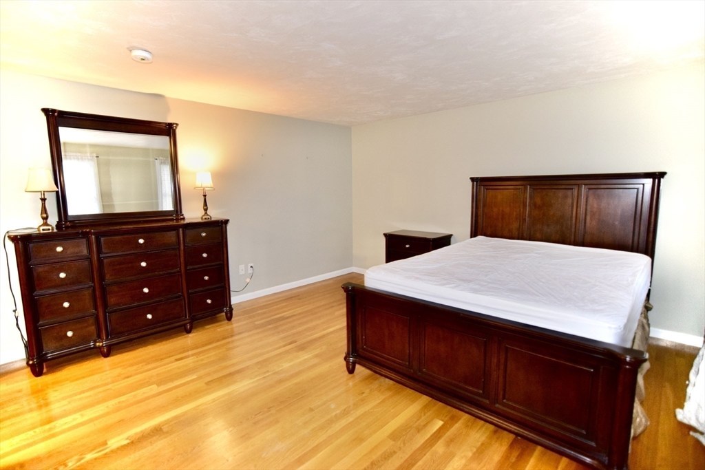 172 Edgehill Road, Unit 172 Norwood, MA 02062 - Photo 9 of 27 a bed room with a bed and a dresser