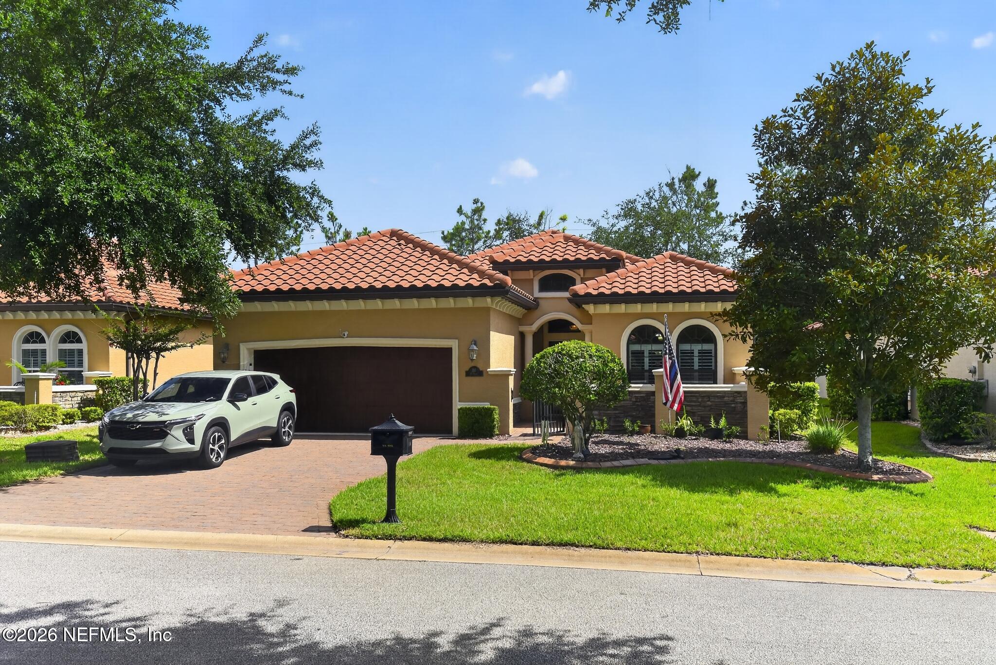 110 Vía Roma Ormond Beach, FL 32174 - Photo 2 of 43 a front view of a house with a garden