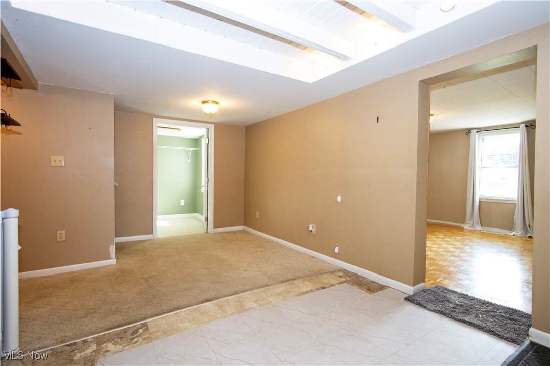 7210 Cleveland Road Wooster, OH 44691 - Photo 6 of 22 Empty room with baseboards and beamed ceiling