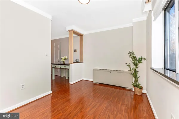 a view of empty room with wooden floor