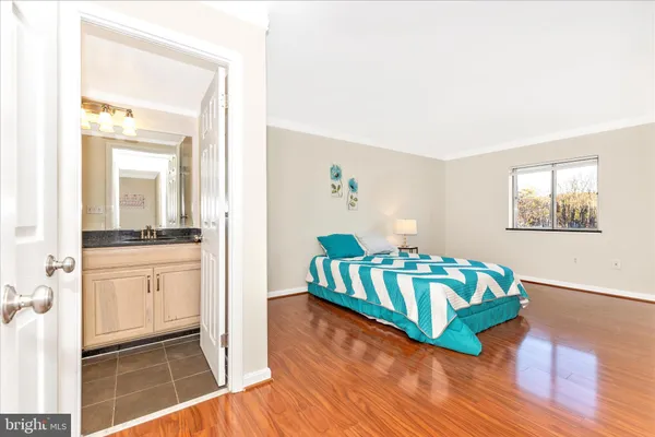 a living room with kitchen island a baby crib furniture a sink and a window