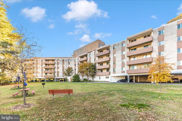 a sign broad in front of the green space