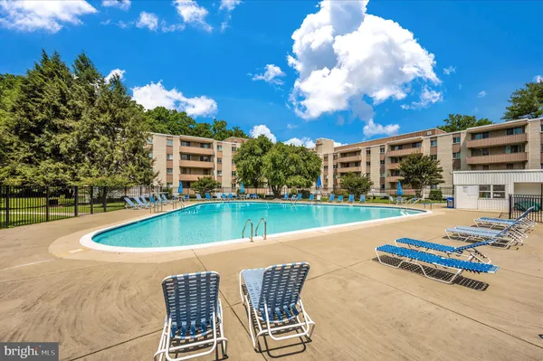 a view of a swimming pool with outdoor seating