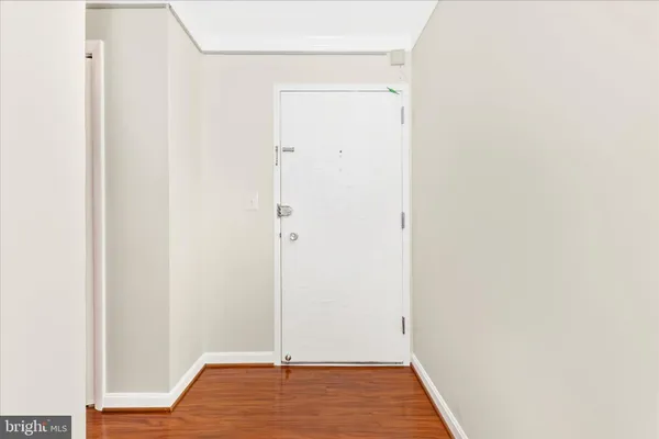a view of hallway with wooden floor