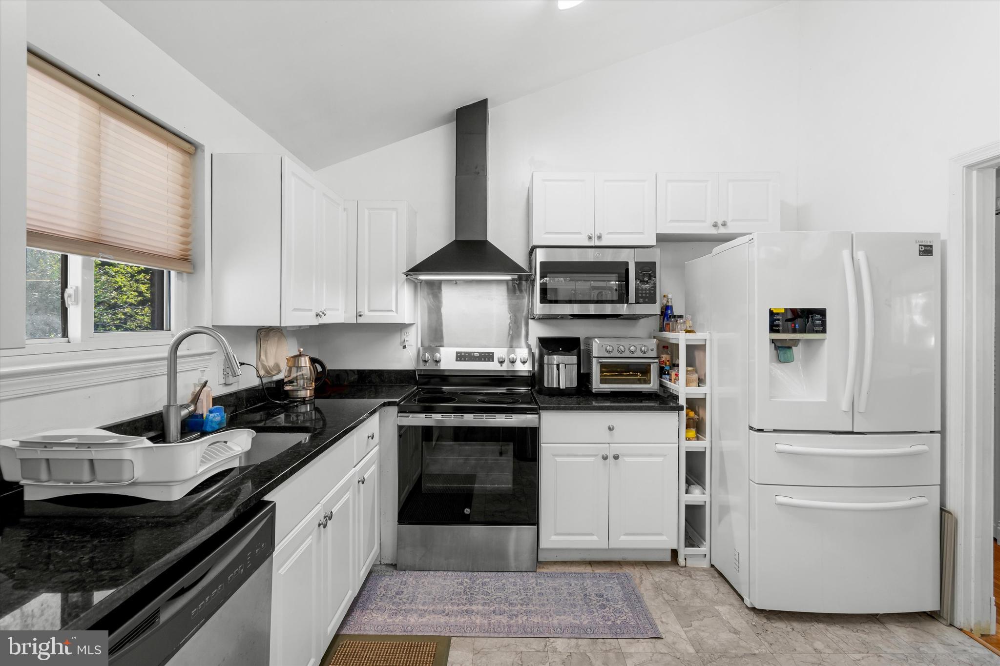 8304 Harland Drive Springfield, VA 22152 - Photo 14 of 39 a kitchen with stainless steel appliances granite countertop a stove a sink and a refrigerator