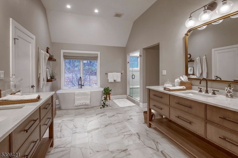 93 Pleasantville Road New Vernon, NJ 07976 - Photo 15 of 41 a spacious bathroom with a double vanity sink a mirror and a bathtub