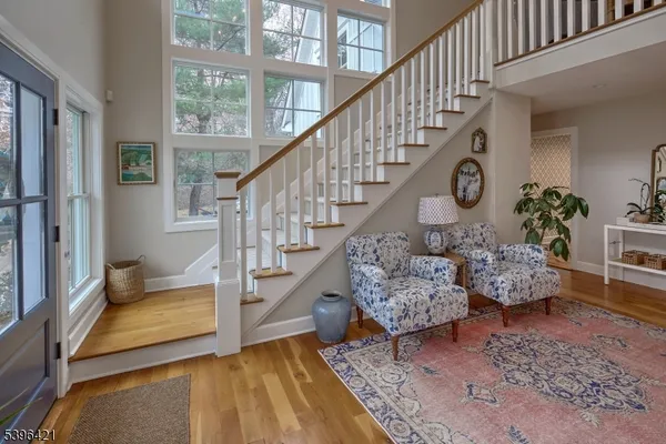 a living room with wooden floor and a rug