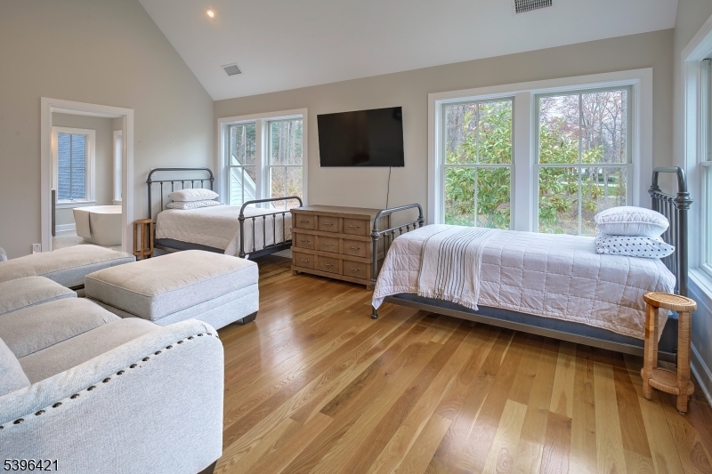 93 Pleasantville Road New Vernon, NJ 07976 - Photo 29 of 41 a bedroom with a bed and a flat screen tv