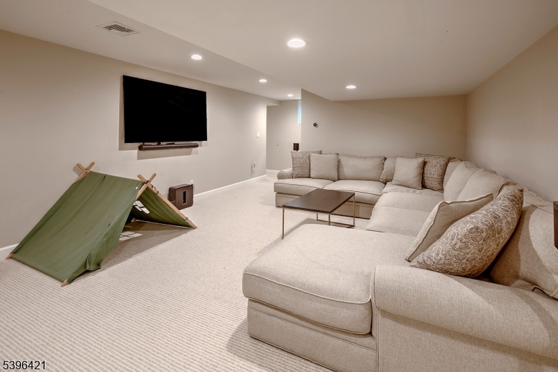 93 Pleasantville Road New Vernon, NJ 07976 - Photo 34 of 41 a living room with furniture and a flat screen tv