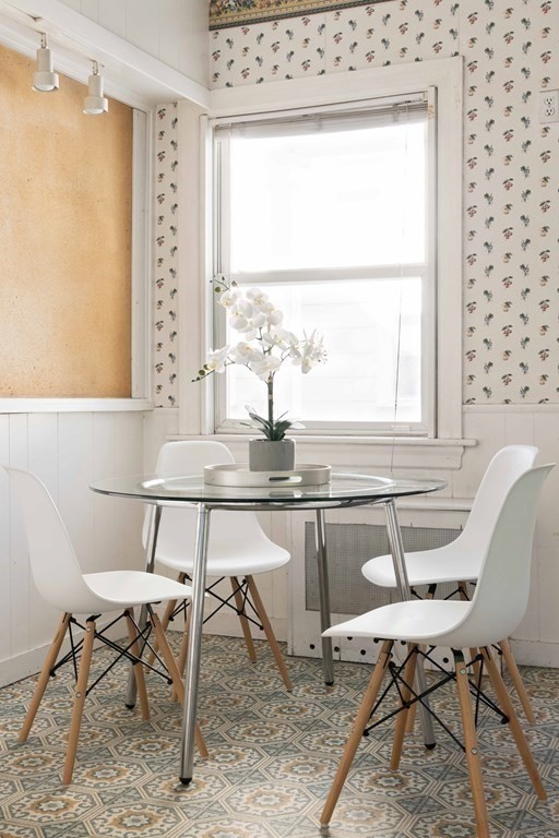 215 Clark Road Brookline, MA 02445 - Photo 12 of 41 a dining room with furniture a window and a rug