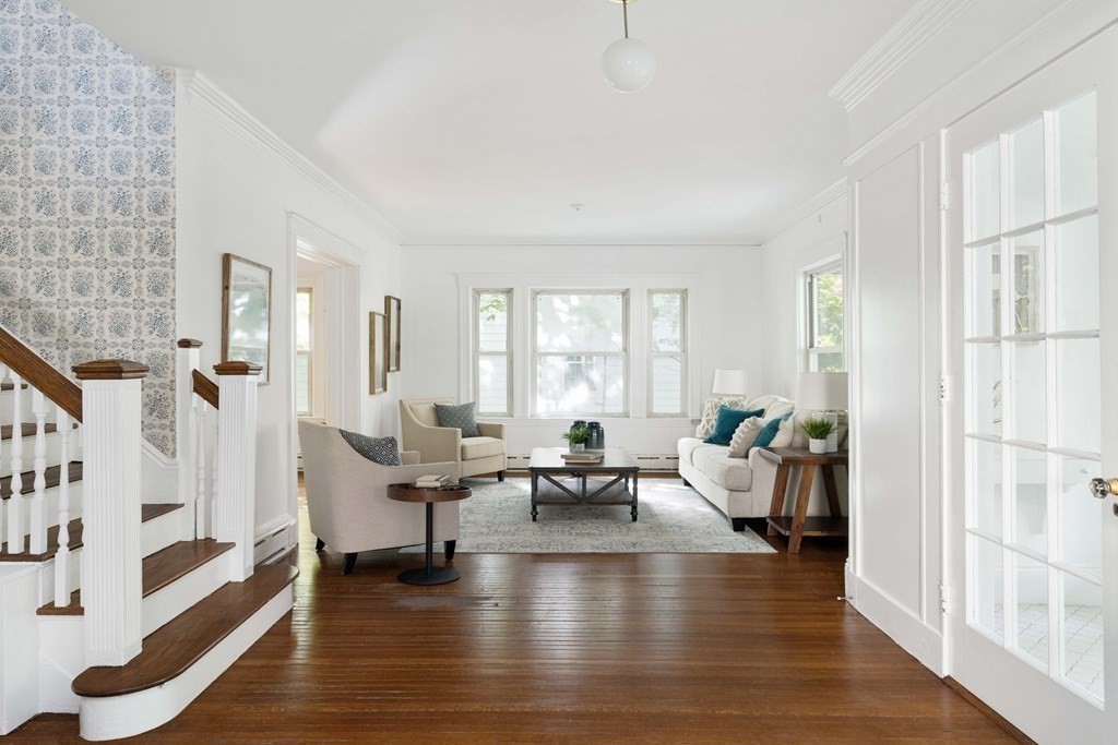 215 Clark Road Brookline, MA 02445 - Photo 23 of 41 a living room with couches and fireplace with wooden floor