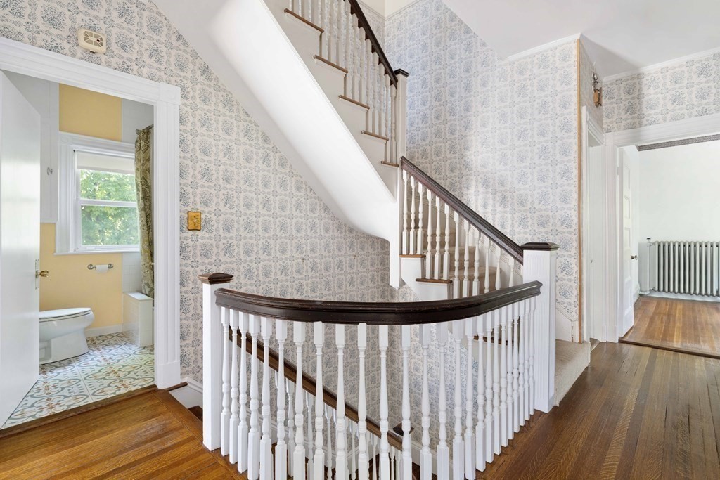 215 Clark Road Brookline, MA 02445 - Photo 27 of 41 a view of staircase with wooden floor and a window