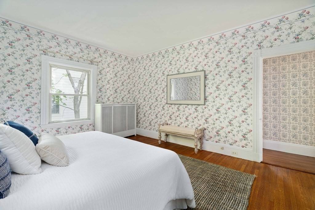 215 Clark Road Brookline, MA 02445 - Photo 29 of 41 a bedroom with a bed and a wooden floor