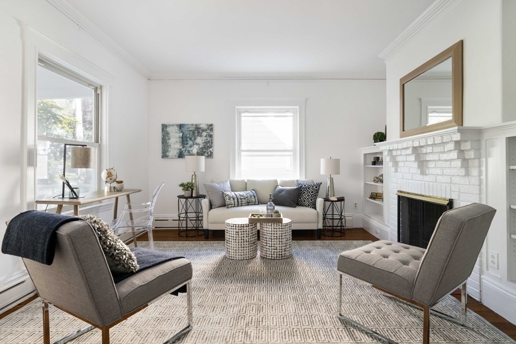215 Clark Road Brookline, MA 02445 - Photo 3 of 41 a living room with furniture or couch and a fireplace