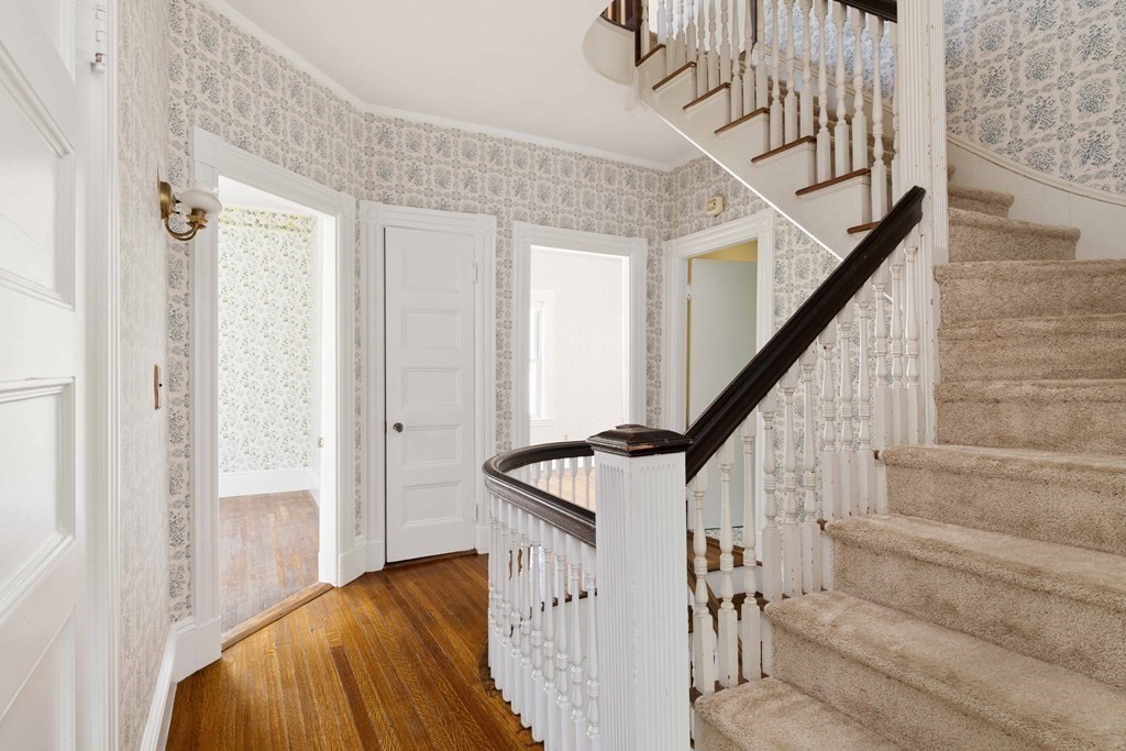 215 Clark Road Brookline, MA 02445 - Photo 32 of 41 a view of staircase with wooden floor and white walls