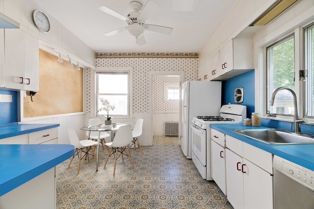 215 Clark Road Brookline, MA 02445 - Photo 9 of 41 a large kitchen with a large window and cabinets