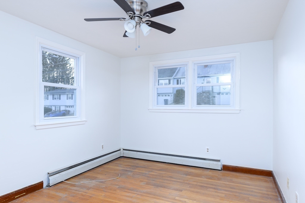 29 Manor Road Auburn, MA 01501 - Photo 18 of 21 a view of an empty room with wooden floor and a window