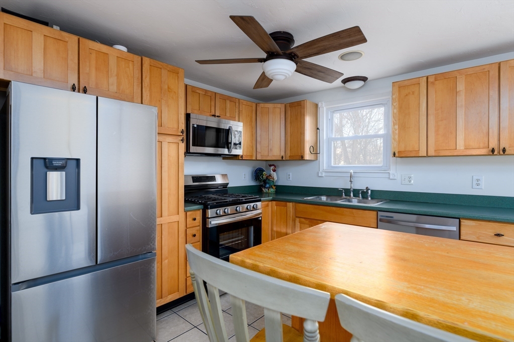 29 Manor Road Auburn, MA 01501 - Photo 7 of 21 a kitchen with stainless steel appliances granite countertop a refrigerator stove microwave and sink