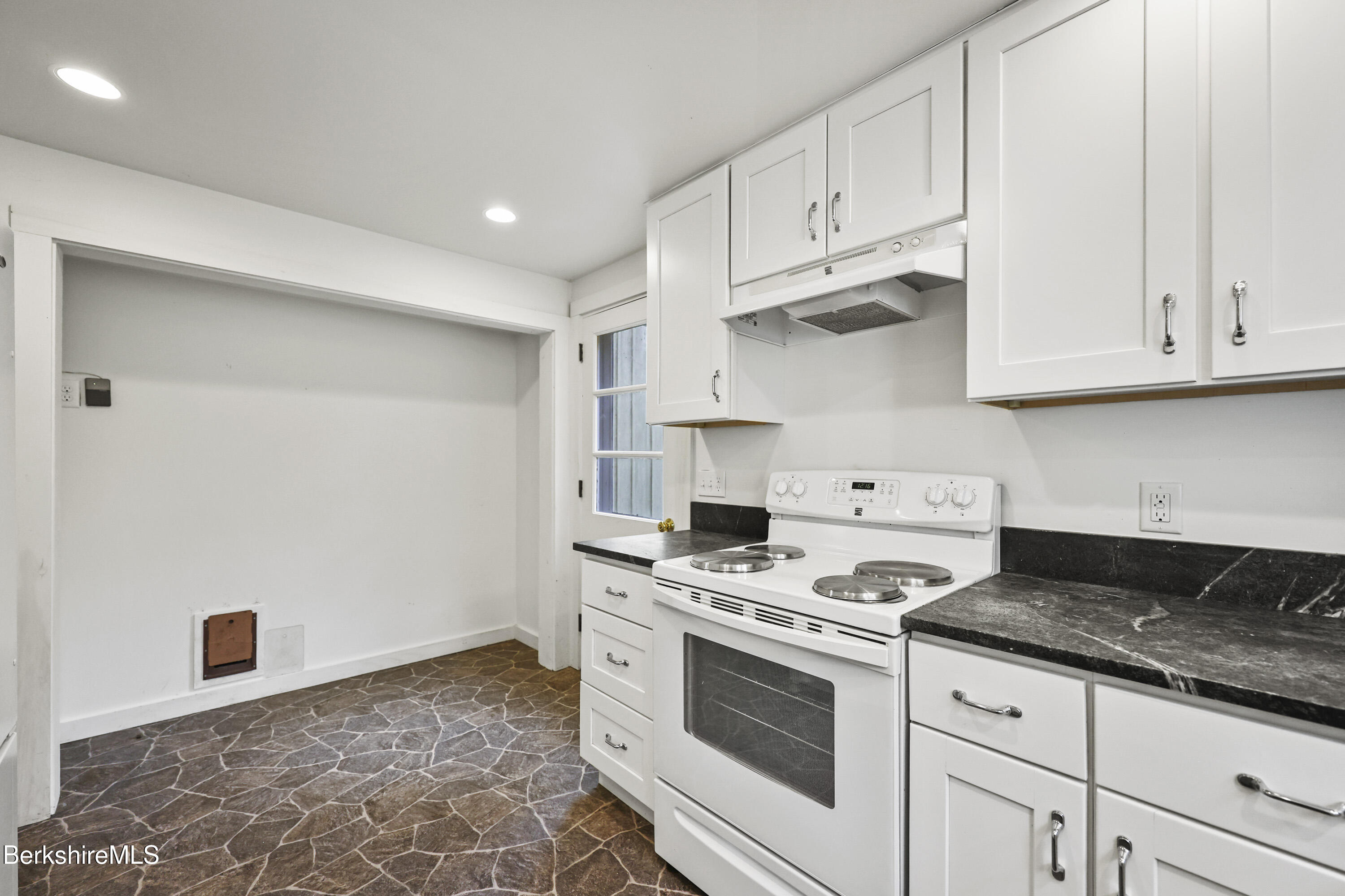 245 Long Pond Road Great Barrington, MA 01230 - Photo 16 of 34 a kitchen with granite countertop white cabinets and white appliances