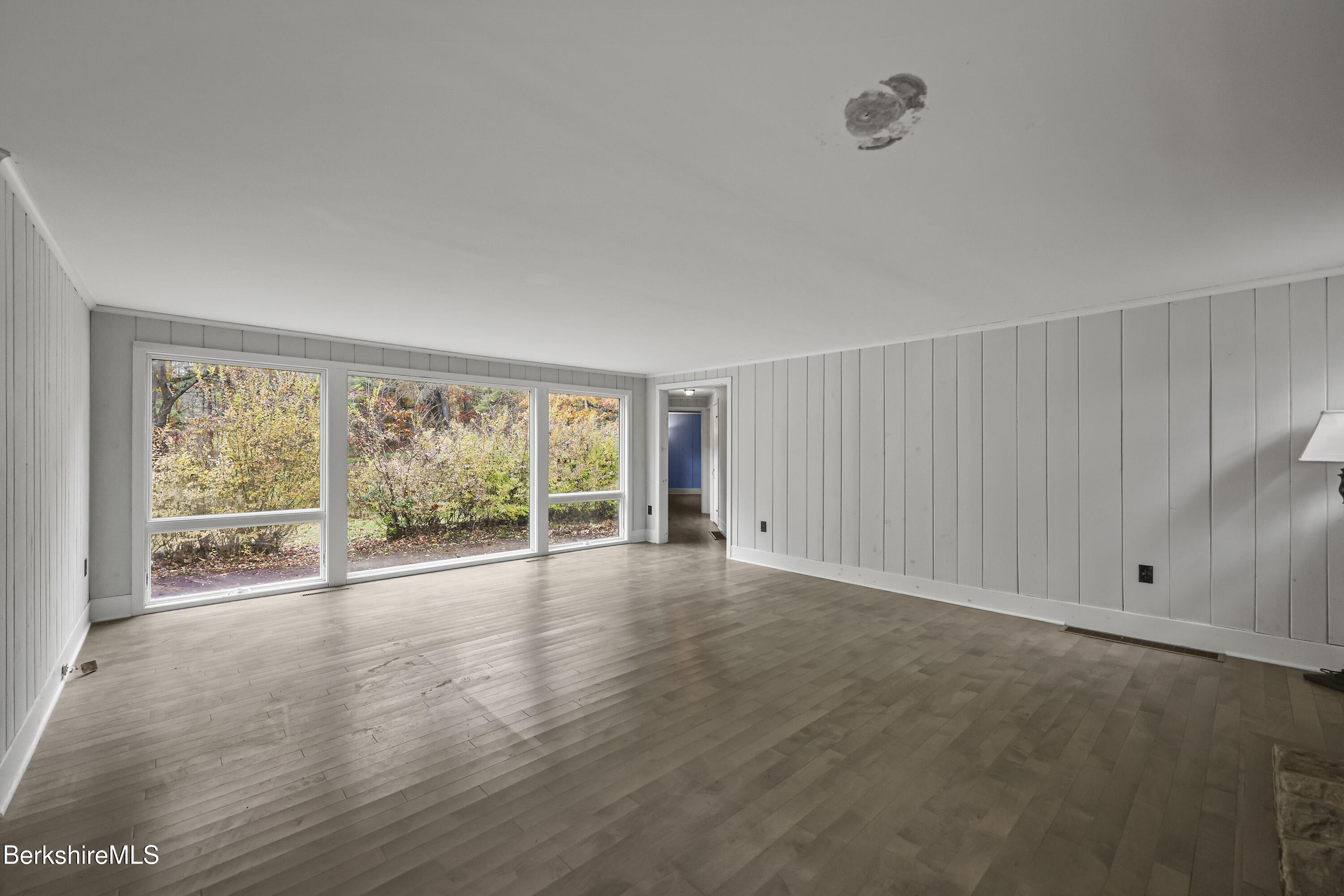 245 Long Pond Road Great Barrington, MA 01230 - Photo 4 of 34 an empty room with wooden floor and windows