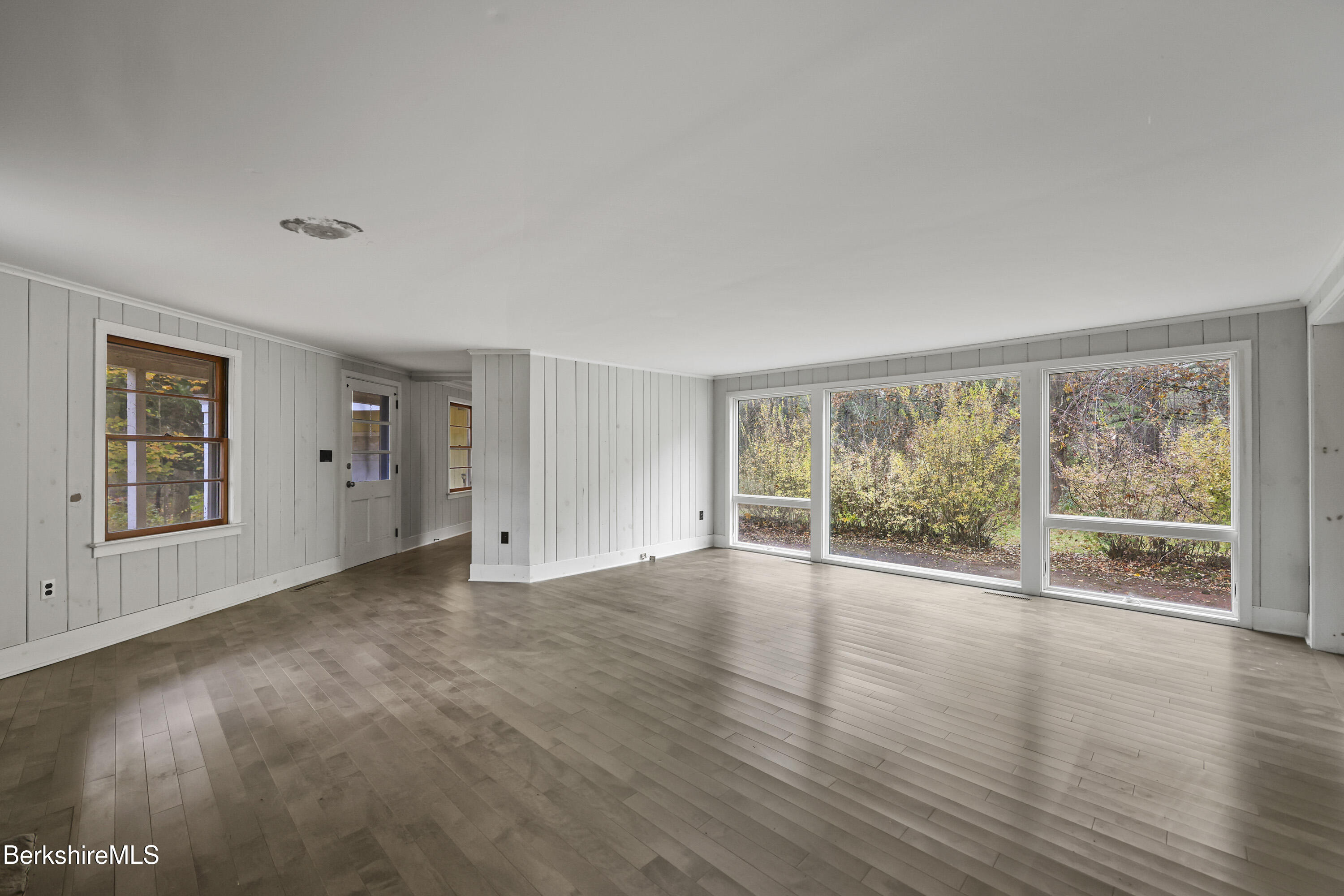 245 Long Pond Road Great Barrington, MA 01230 - Photo 5 of 34 a view of empty room with wooden floor and fan