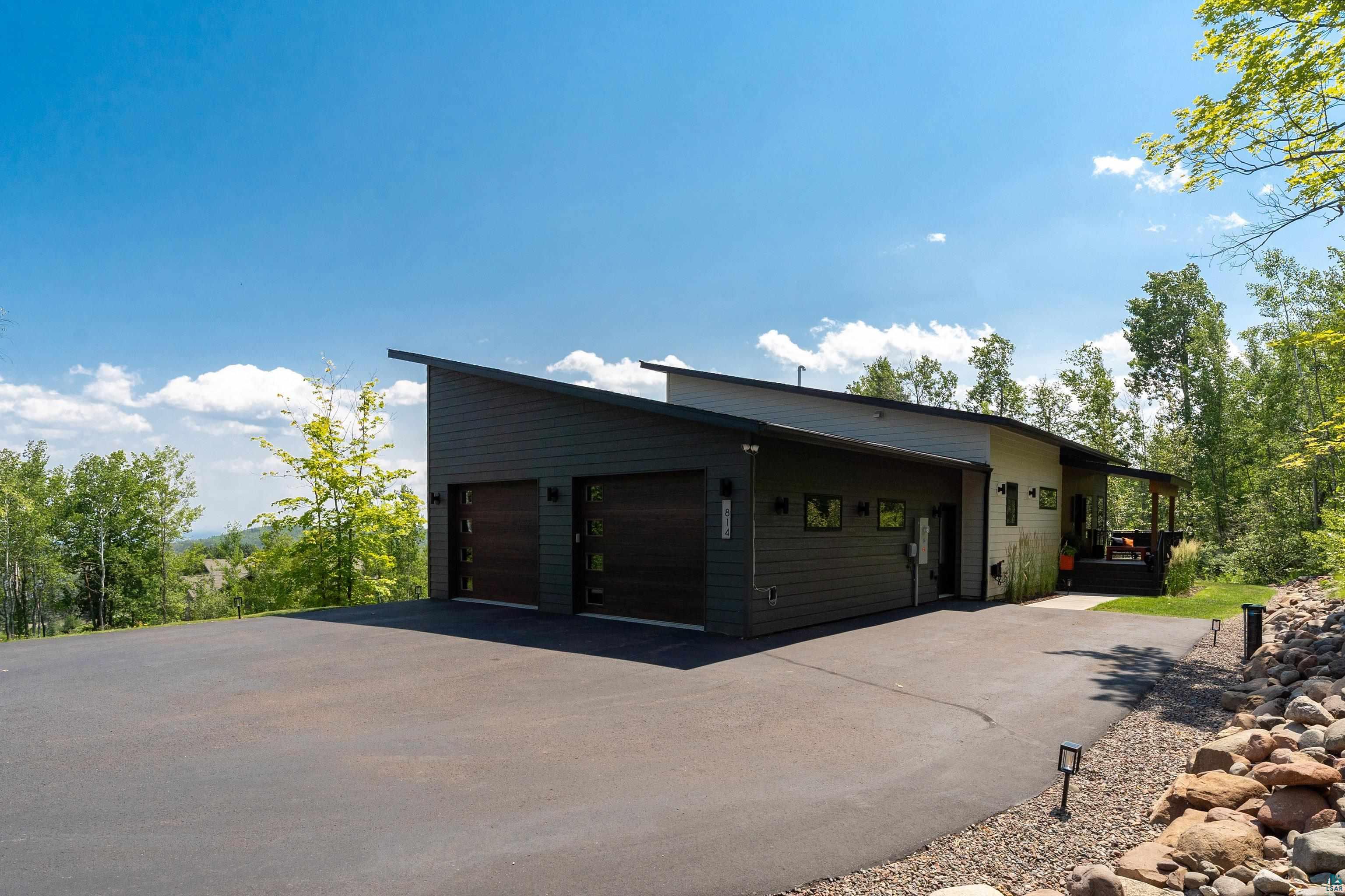 814 Pleasant View Road Duluth, MN 55803 - Photo 42 of 49 Contemporary exterior design with a distinctive shed roofline, featuring dark siding and light-toned accents