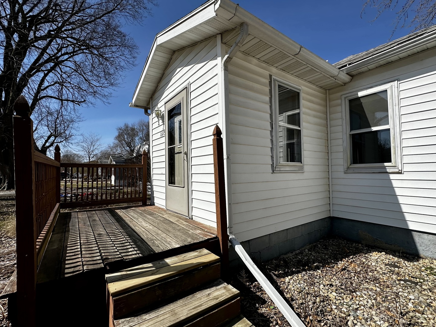 1619 East Washington Street Clinton, IL 61727 - Photo 3 of 32 a view of a roof deck with wooden floor and fence with a barbeque grill