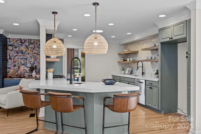 a kitchen with stainless steel appliances granite countertop a sink a stove and a wooden floors