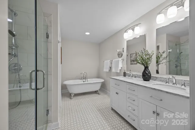 a bathroom with a double vanity sink mirror and shower