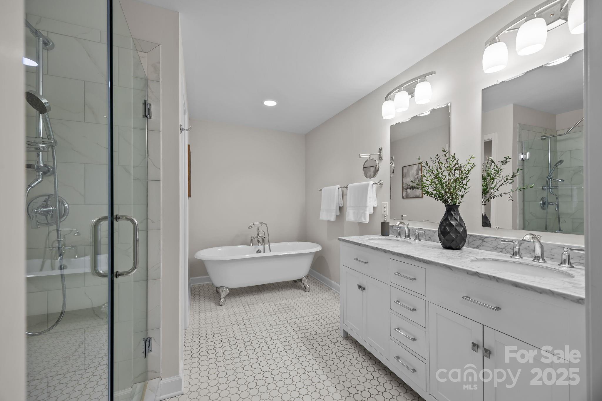 1022 Churchill Road Davidson, NC 28036 - Photo 20 of 39 a bathroom with a double vanity sink mirror and shower