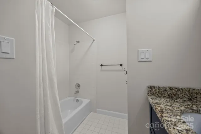 a bathroom with a bathtub and shower