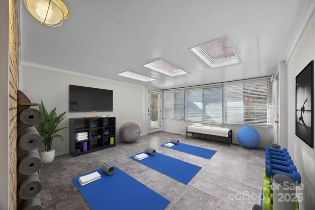 a bedroom with furniture and a flat screen tv