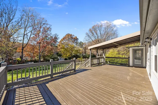 a view of a balcony with wooden floor and fence