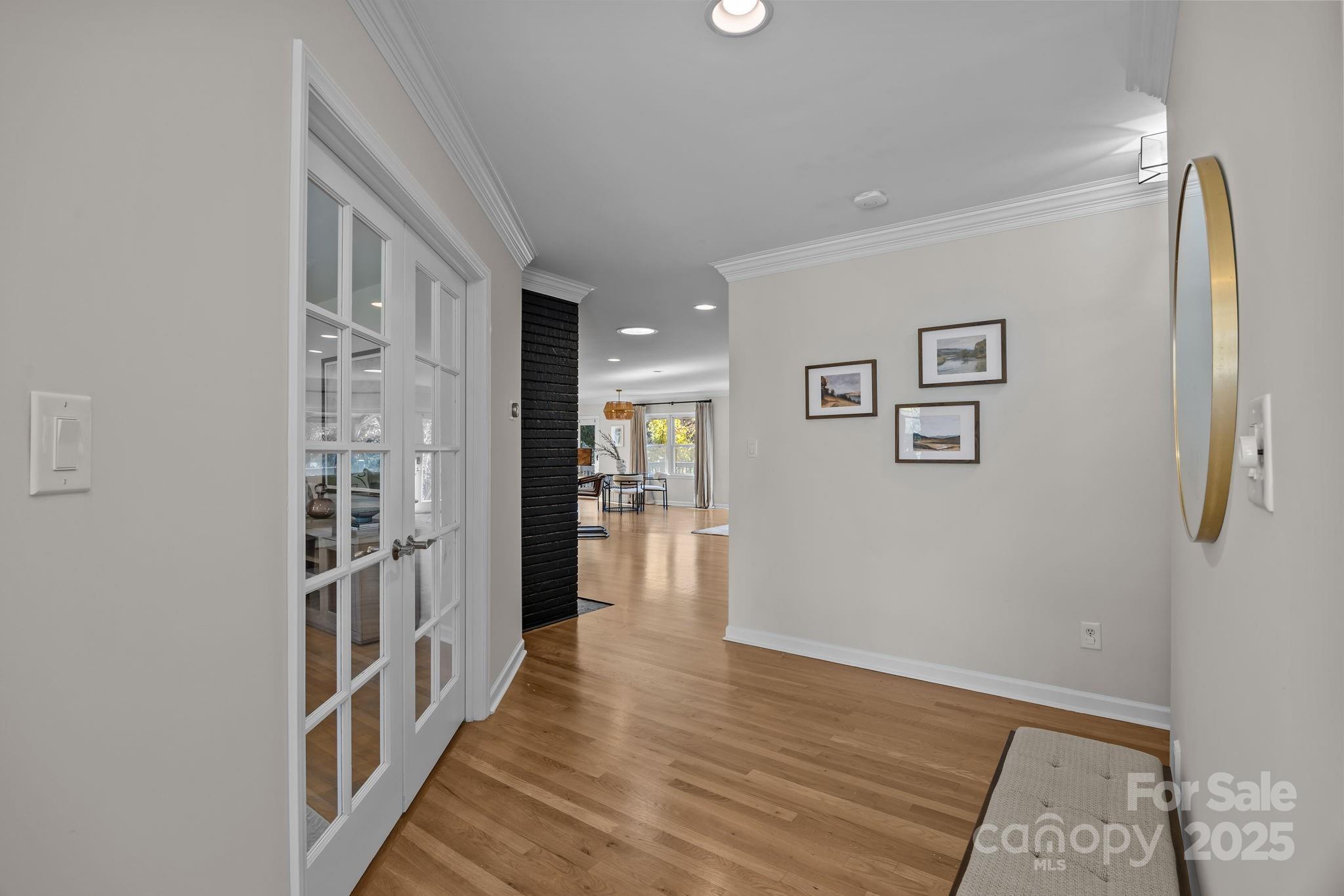 1022 Churchill Road Davidson, NC 28036 - Photo 6 of 39 a view of a hallway with wooden floor and a bathroom