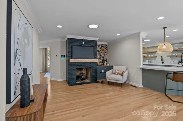 a living room with furniture a fireplace and a flat screen tv