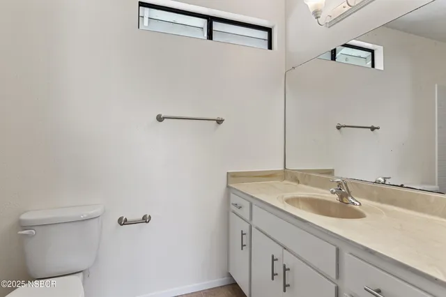 an empty room with closet and windows