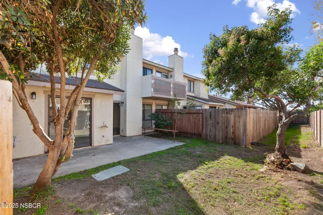 a view of a garden with a building in the background