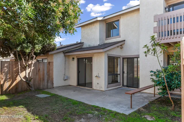 a view of a house with a yard and plants