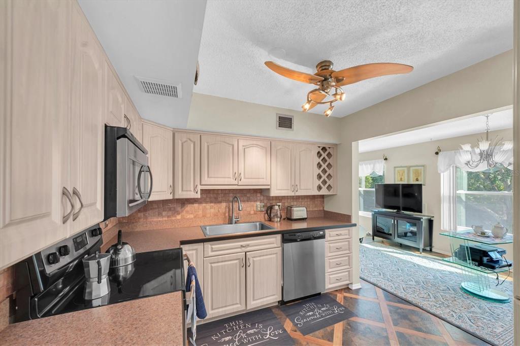 2469 Franciscan Drive, Unit 53 Clearwater, FL 33763 - Photo 12 of 51 a kitchen with a sink stove and cabinets