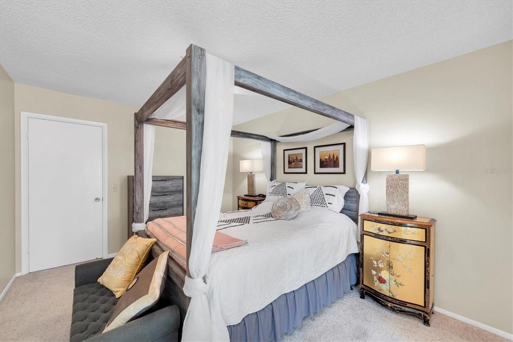 2469 Franciscan Drive, Unit 53 Clearwater, FL 33763 - Photo 19 of 51 a bedroom with a bed and wooden floor