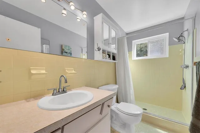 a bathroom with a sink toilet and shower