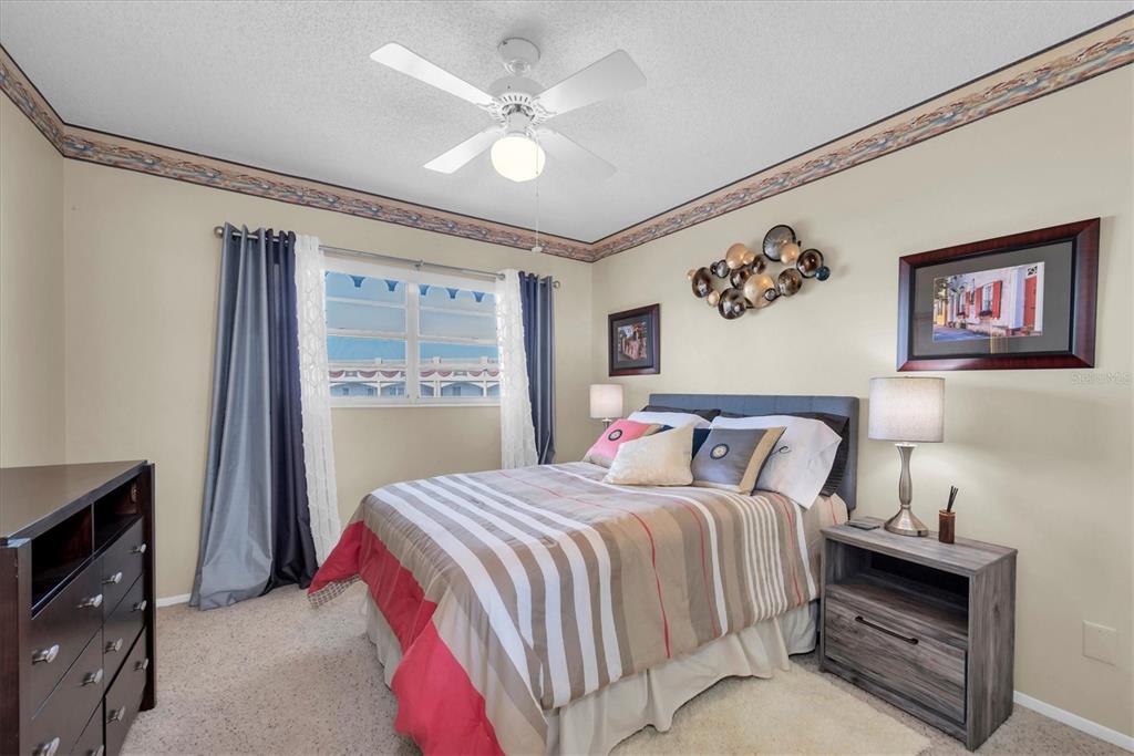 2469 Franciscan Drive, Unit 53 Clearwater, FL 33763 - Photo 21 of 51 a bedroom with a large bed and a chandelier