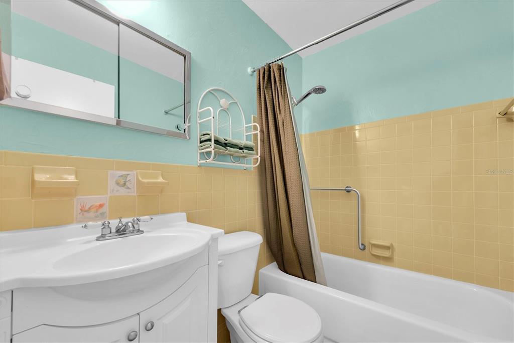 2469 Franciscan Drive, Unit 53 Clearwater, FL 33763 - Photo 23 of 51 a bathroom with a sink a toilet and a mirror