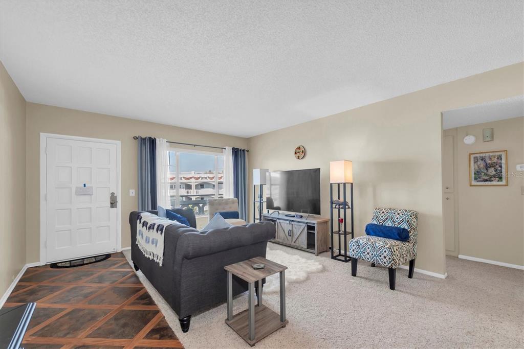 2469 Franciscan Drive, Unit 53 Clearwater, FL 33763 - Photo 4 of 51 a living room with furniture and a flat screen tv