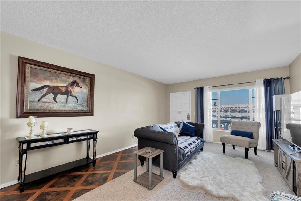 2469 Franciscan Drive, Unit 53 Clearwater, FL 33763 - Photo 6 of 51 a living room with furniture a piano and a flat screen tv