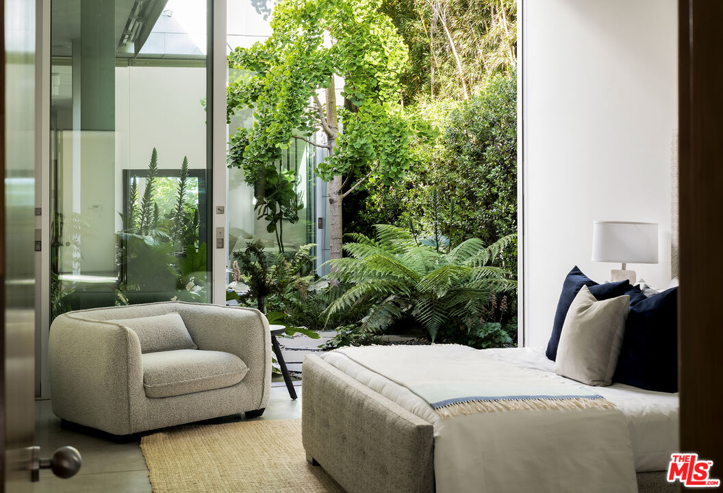 702 6th Avenue Venice, CA 90291 - Photo 13 of 27 a bedroom with furniture and a potted plant