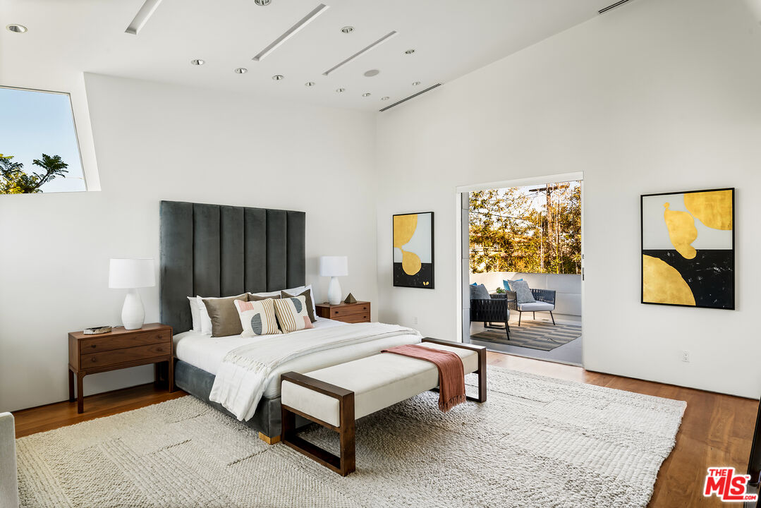702 6th Avenue Venice, CA 90291 - Photo 17 of 27 a bedroom with a bed and wooden floor