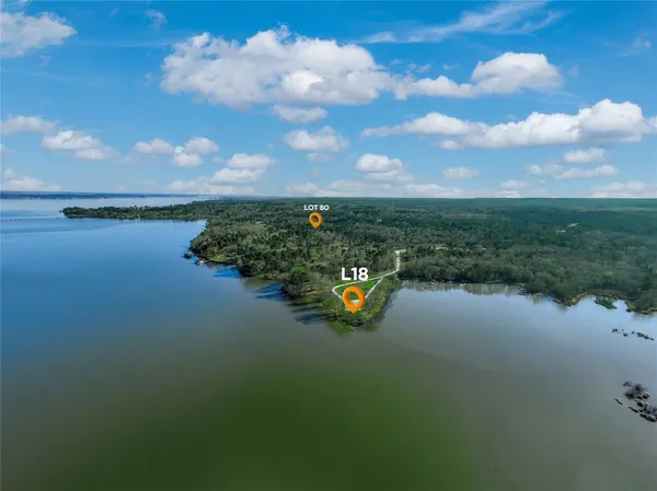 a view of a lake with table and chairs