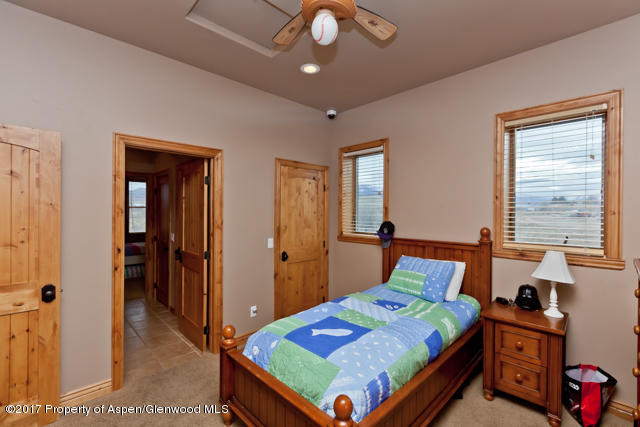 454 35 Road Palisade, CO 81526 - Photo 11 of 28 a bedroom with a bed and wooden floor